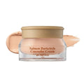 SKINFOOD Salmon Dark Circle Eye Concealer Cream 01 Blooming clear glass jar with gold lid and peach cream swatch
