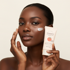 Black woman applying SKINFOOD Tomato Tone Up Sun Cream to cheek, luminous radiant skin — Glow Ritual
