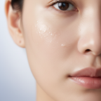 Close-up of smooth glowing skin with serum droplets after using Medicube Zero Pore Pad
