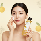 SKINFOOD Yuja C Dark Spot Clear Toner – Elegant Asian model applying toner with cotton pad
