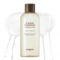 SKINFOOD Carrot Carotene Soothing Toner 300ml cream bottle with brown cap and watery toner splash on white background
