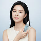 Elegant Asian woman holding SKINFOOD Blue Chamomile Hyaluronic Ampoule for soothed calm sensitive skin
