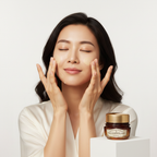 Asian woman patting SKINFOOD Royal Honey Propolis Barrier Cream for radiant skin
