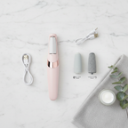 Pink electric callus remover with fine and coarse sand roller heads, USB charging cable, towel and cream on marble background – flat lay
