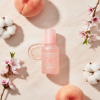 SKINFOOD Peach Cotton Zinc PCA Essence with fresh peaches peach blossoms and cotton flowers flat lay
