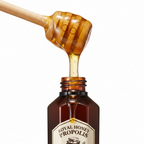 Golden honey drizzle on SKINFOOD Royal Honey Propolis Toner bottle — nourishing skincare ingredient
