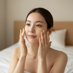 Korean woman in her 20s patting Beauty of Joseon Revive Serum onto face with both hands, dewy glowing skin
