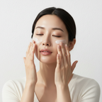 Anua Zero-Cast Moisturizing Finish Sunscreen 50ml – Korean model applying lightweight moisturizing sunscreen onto face with fingertips for SPF protection

