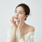 Round Lab Camellia Deep Collagen V-Lifting Gel Mask – Korean model applying skincare with cream robe and products
