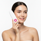 Caucasian woman holding a white ultrasonic skin scrubber with dust cap on, hot pink circular button, beauty editorial style
